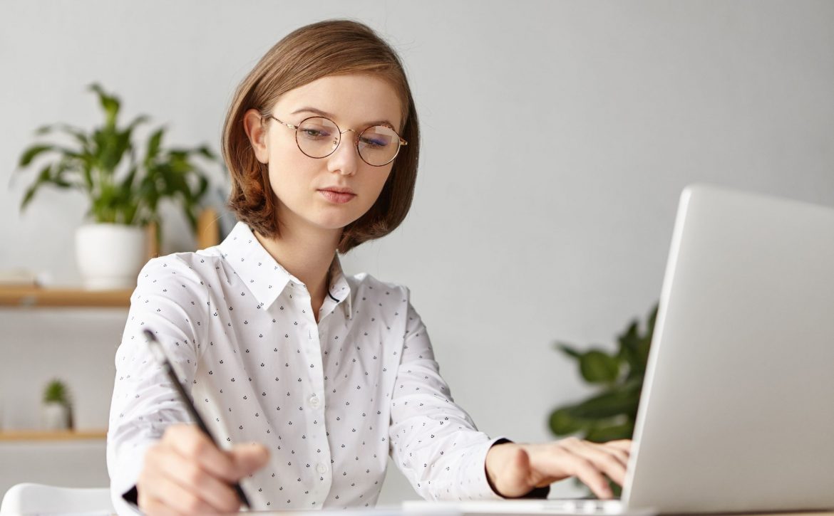 elegant-businesswoman-dressed-formally-sitting-with-laptop