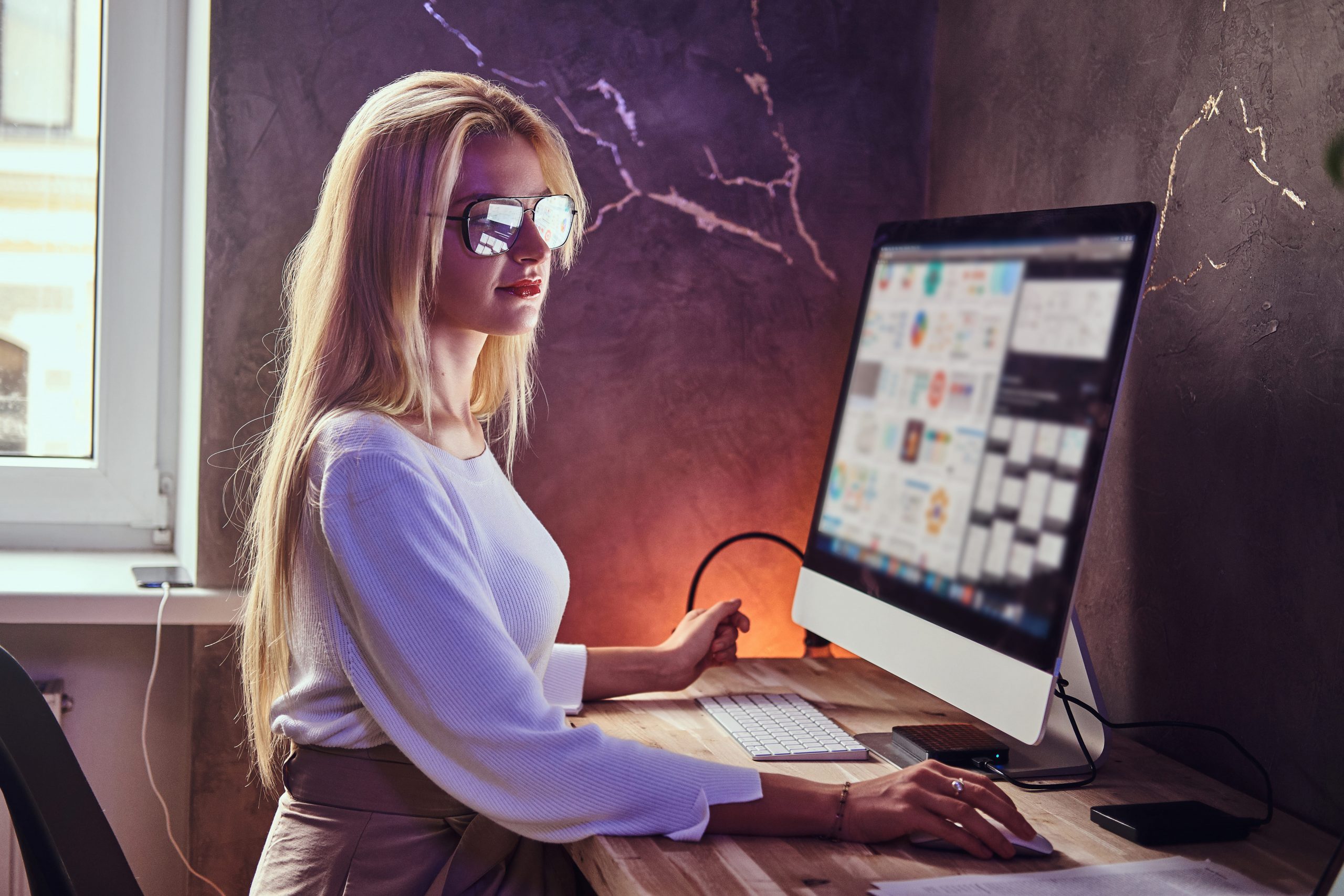 attractive-blond-girl-is-studying-her-modern-room-using-computer
