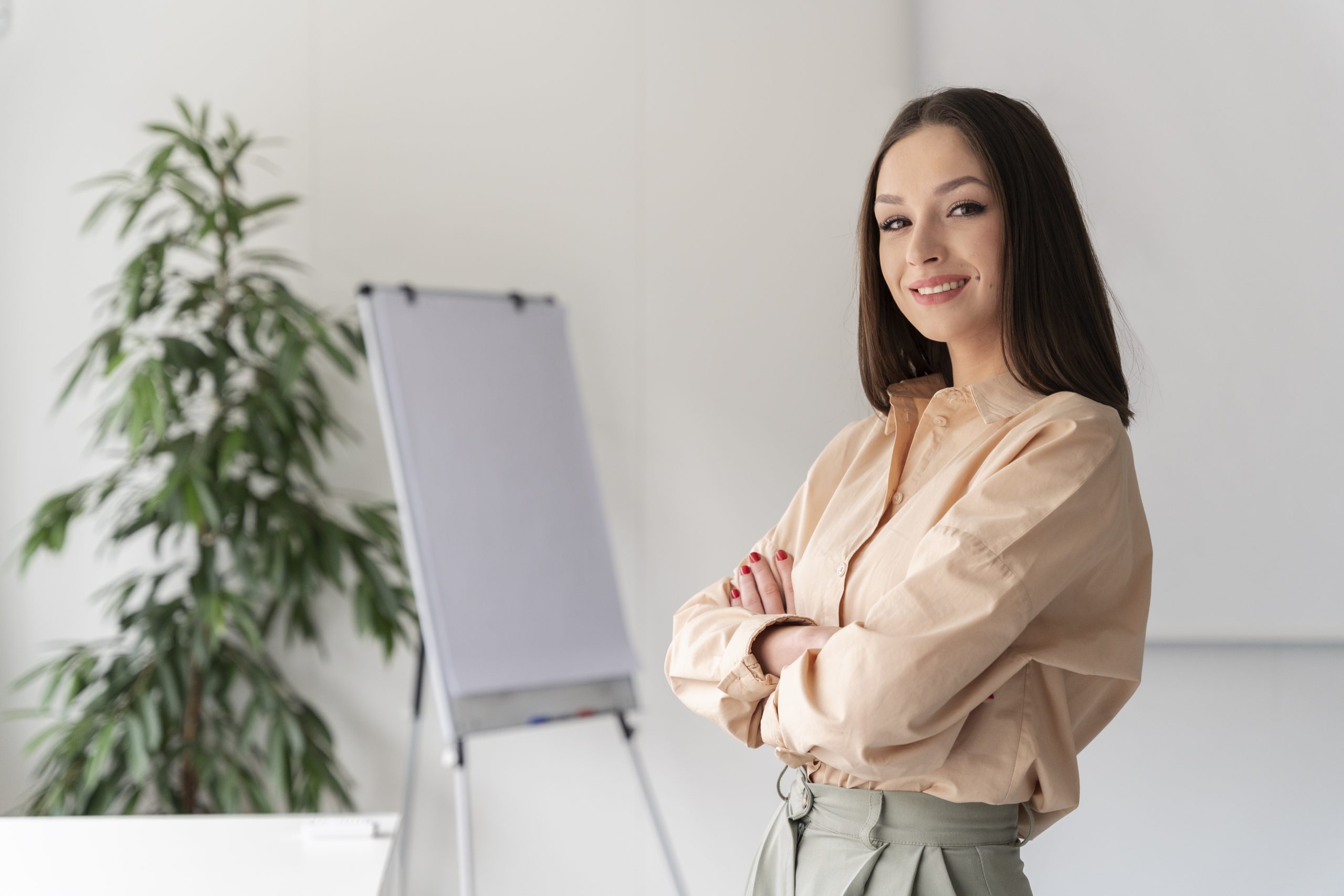 portrait-young-business-woman-posing-with-crossed-arms-scaled.jpg