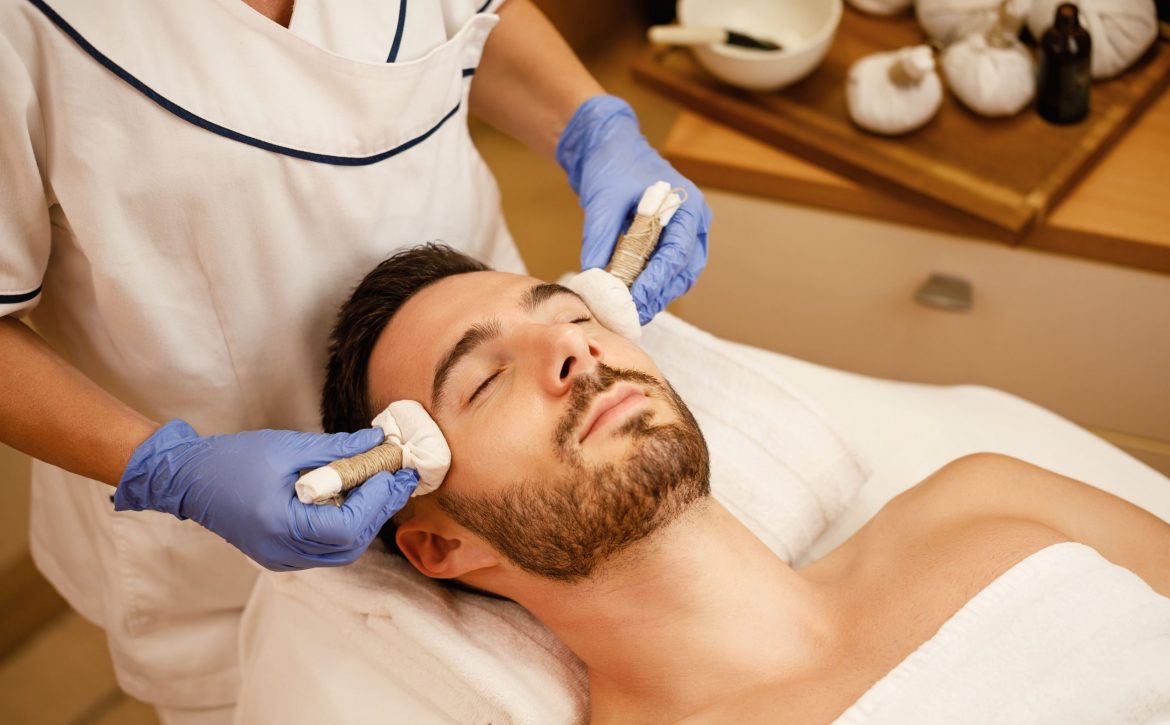 relaxed-man-having-thai-herbal-head-massage-wellness-center (1)