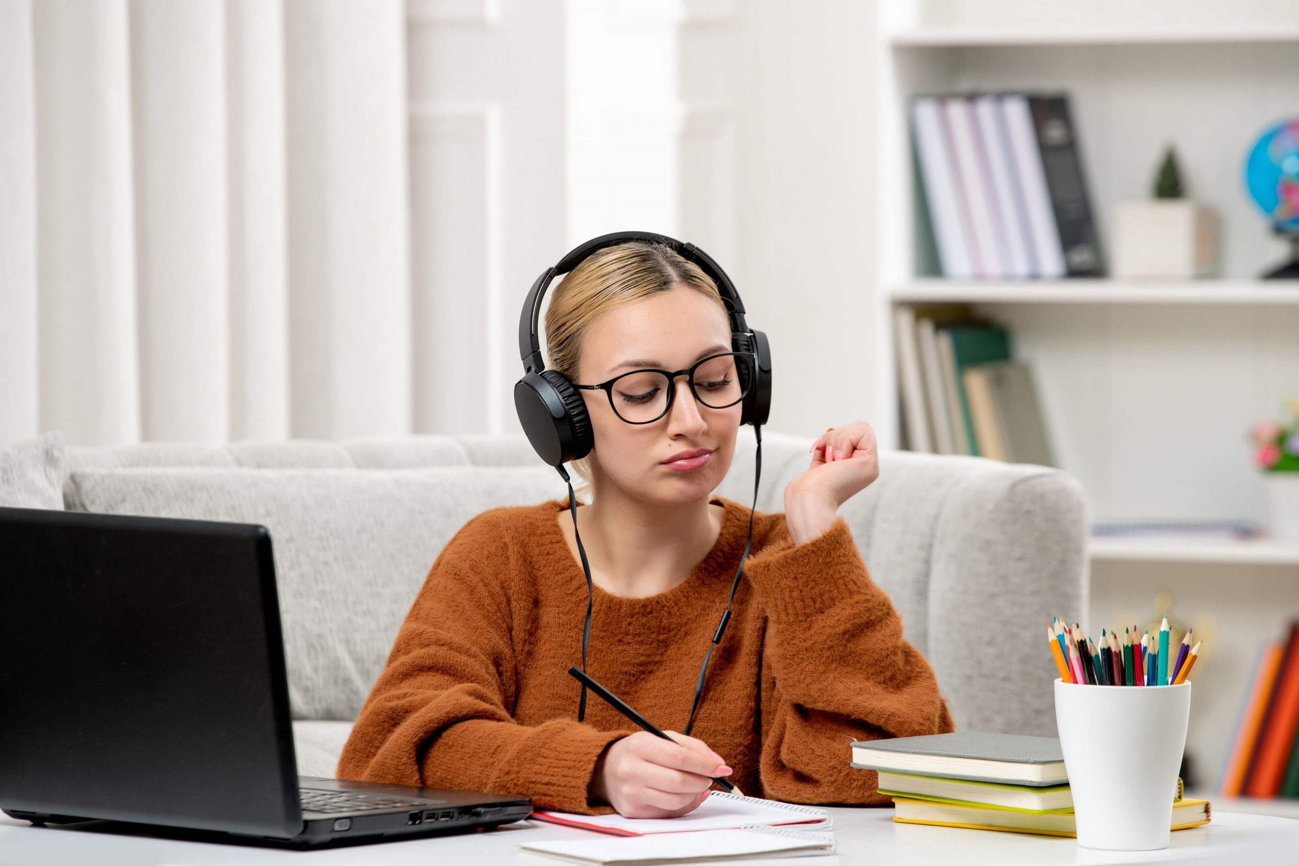 student-online-cute-girl-glasses-sweater-studying-computer-taking-down-notes (1)